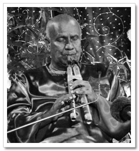 Sri Chinmoy playing one of 74 flutes Sri Chinmoy playing one of 74 flutes